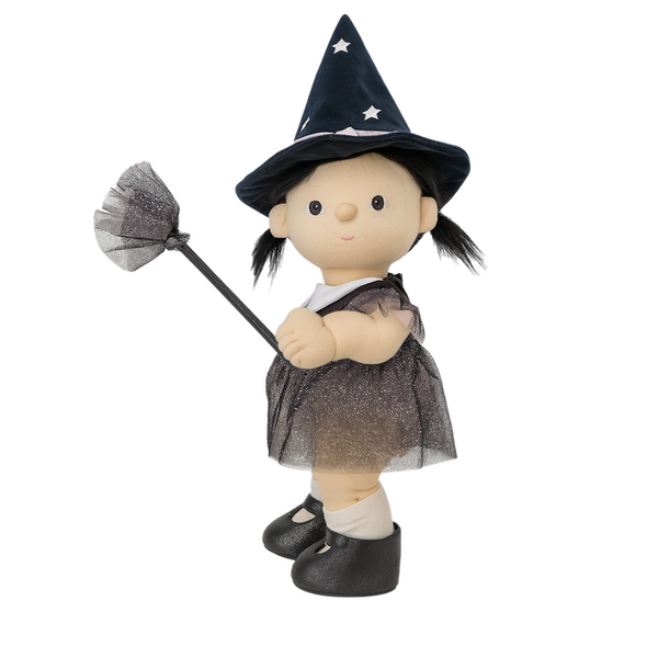 Toy doll dressed as a witch with a broom on a white background