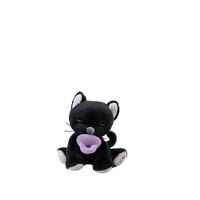 Black plush toy with a purple pacifier on a white background