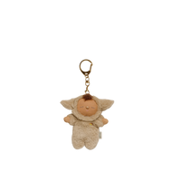Plush keychain of a baby character with a gold ring on a white background