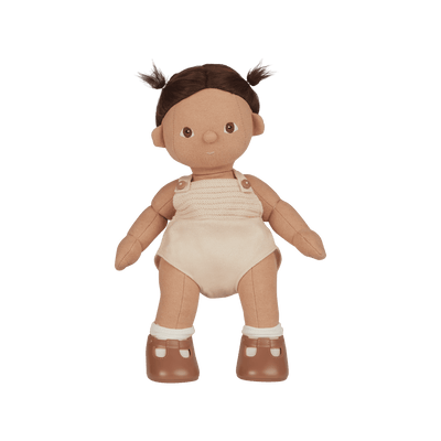 Plush baby doll with brown hair, beige romper, and brown shoes on a white background
