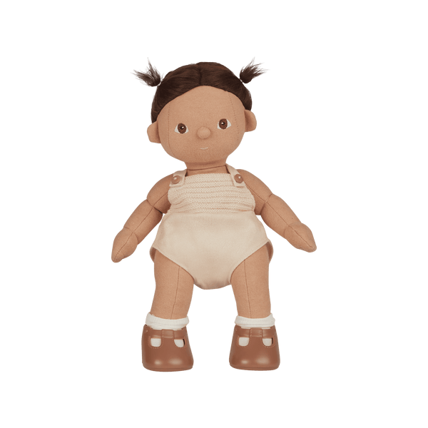 Plush baby doll with brown hair, beige romper, and brown shoes on a white background