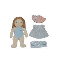 Plush doll with blue outfit, pink hat, and checkered bag on a black background