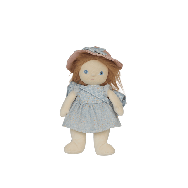 Stuffed doll with a blue dress and pink hat on a black background