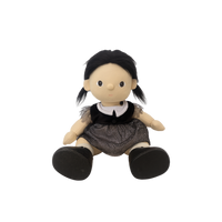 Toy doll with black hair, wearing a black top and brown skirt on a white background