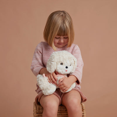 Olli Ella Dinkum Dog Cookie - White Dog, Pink Harness held by child