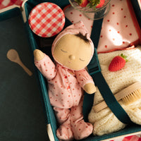 Olli Ella Dozy Dinkum Doll - strawberry. Floppy soft-doll suitable from birth with pink strawberry printed onesie,