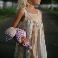 Olli Ella Dozy Dinkum Doll - Plum Check. Floppy soft-doll suitable from birth with purple check printed onesie,