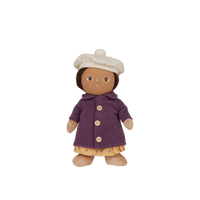 Toy doll with a purple coat and white hat on a white background