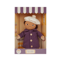 Doll in a purple coat and white hat in packaging with striped awning