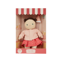 Doll in a pink outfit with a matching box on a white background