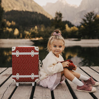 Olli Ella See-Ya Suitcase Christmas theme Sweetheart Red print pictured with child with a washbag